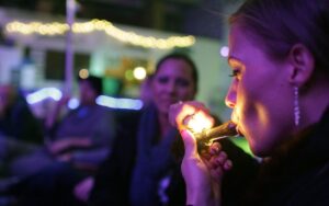 A woman is smoking a cigarette in public.