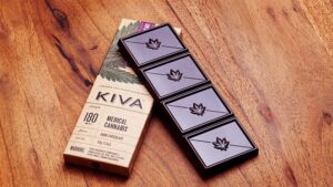 A marijuana infused chocolate bar and a box on a table.