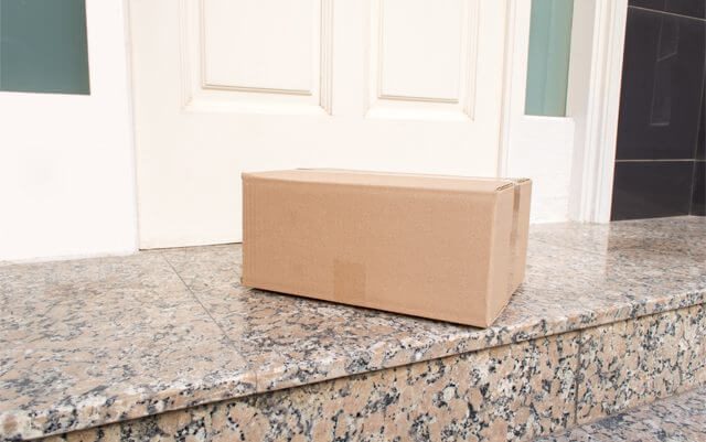 A marijuana delivery box on a marble counter.