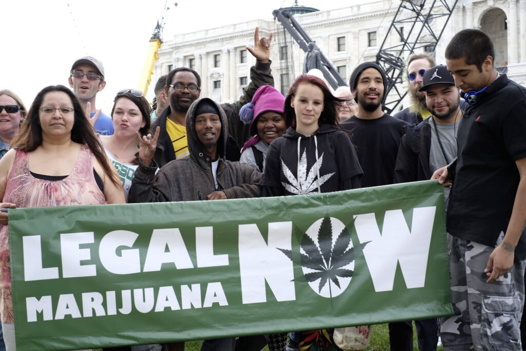 Gathering of advocates with signs promoting marijuana legalization.