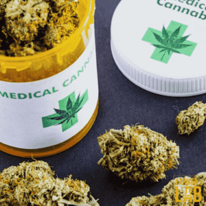 A jar of medical cannabis next to a bunch of marijuana.